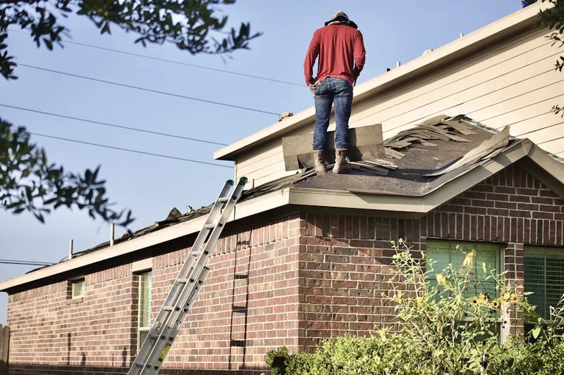 Professional roofer working on a residential roof in Old Lyme